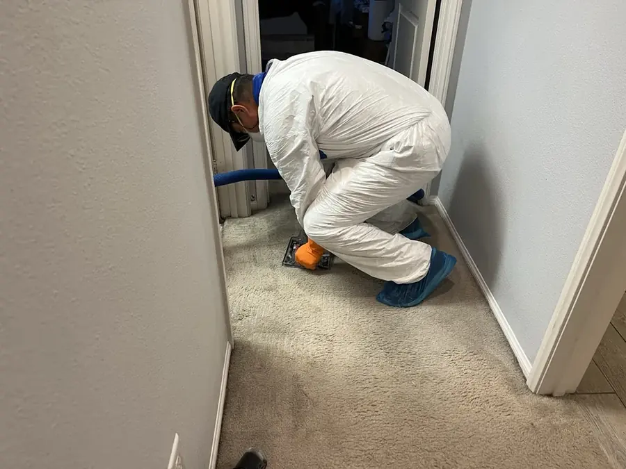 A technician checking a moisture reading in an Arlington, VA home