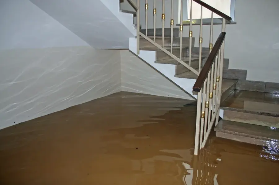 A flooded lower level and staircase in an Arlington, VA home, ready for water extraction